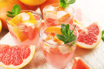 Ripe grapefruits and fresh juice with mint, close up