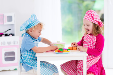 Kids playing with toy kitchen