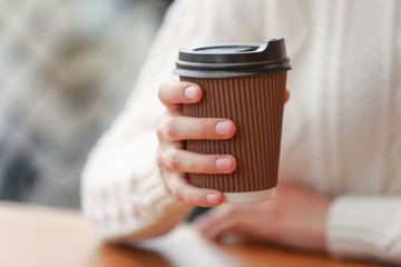 Fototapeta na wymiar Young woman drinking coffee in cafe