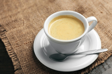 Cup of coffee on tablecloth