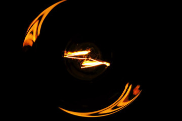Illuminated light bulb on black background