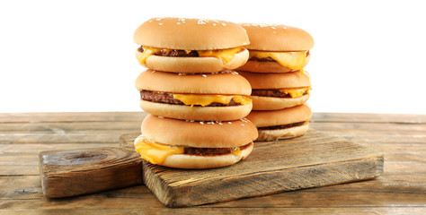Tasty cheeseburgers on cutting board, isolated on white