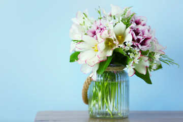 Bouquet of spring flowers on wall background