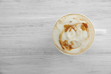 Cup of fresh coffee on wooden background