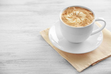 Cup of fresh coffee on napkin