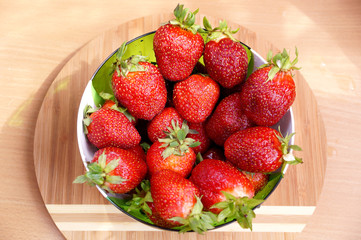 Fresh strawberry in a transparent salad bowl