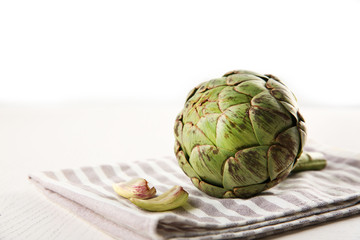 Raw artichoke on napkin
