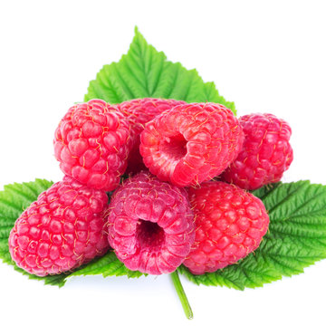 Fresh, ripe raspberries over green leaves, isolated on white background.