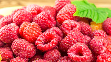 Pile of fresh, ripe raspberries, fruit background.