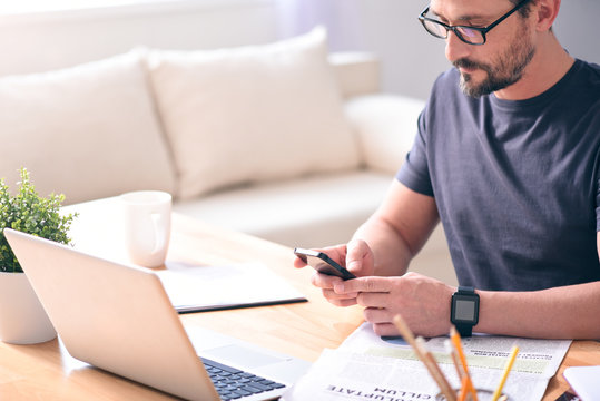 Man Looking At Screen Of Phone