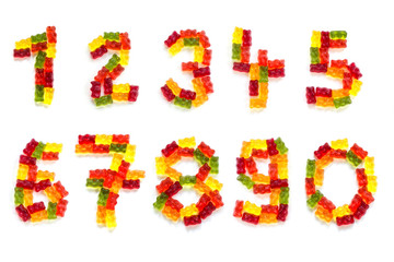  digits from 0 to 9 made of colorful gummy bears isolated on white