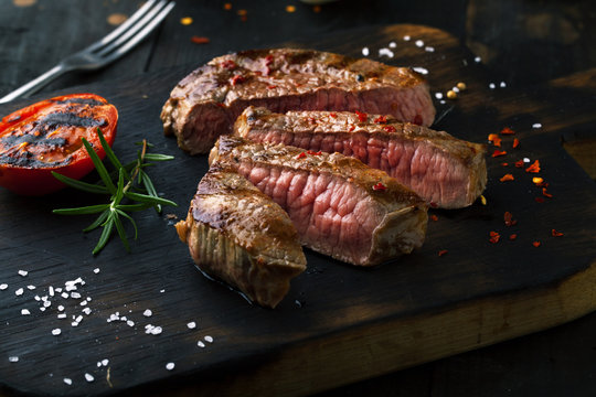 Sliced medium rare grilled  Steak Ribeye with rosemary