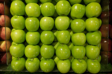 healthy fresh green apple stall between red apple stall in supermarket.