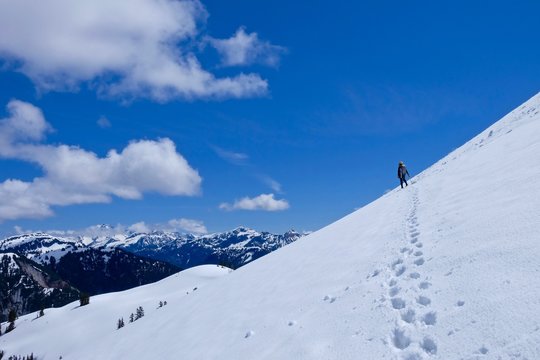 Man climber on steep snow mountain slope. Ruth Mountain near Bellingham, North Cascades National park, Washington, USA. 