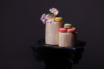 Macaron with flowers on wood stump