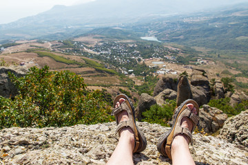 Men in sport sandals lies on the top of Demerdzhi mountain. Close up detail of male feet. Relax...