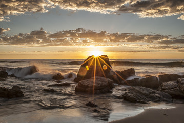 Sunset sunburst over the rocks at O'Sullivan's Beach, South Australia