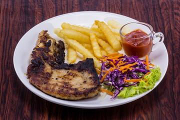 Steak cooked more on white plate