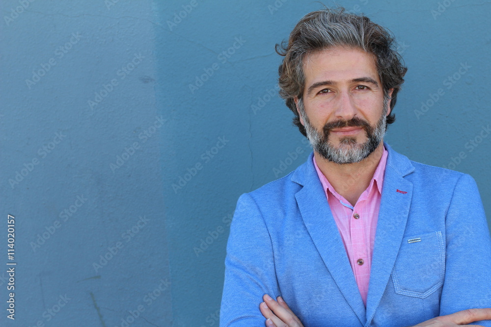 Wall mural portrait of mature business man with grey beard and hair alone crossing his arms with copy space