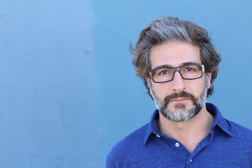 Studio Portrait of a handsome businessman wearing glasses looking to the camera with copy space  © ajr_images