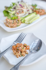 Hot and spicy seafood salad shrimp, salmon vegetables and chillies in Thai what we called Larb Talay  local style the northeastern delicious food of Thailand.