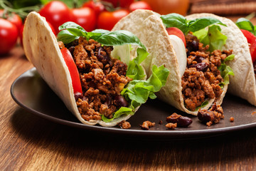 Mexican tacos with minced meat, beans and spices
