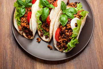 Mexican tacos with minced meat, beans and spices