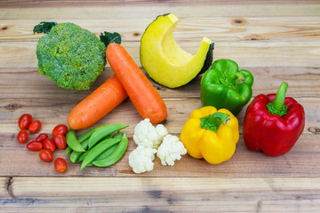 Variety fresh vegetable on wooden background.