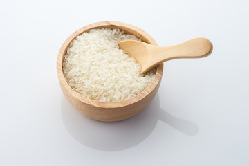 Fototapeta na wymiar wooden bowl of jasmine rice grain on white background