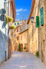 Montepulciano, Italy. Old narrow street in the center of town with colorful facades.