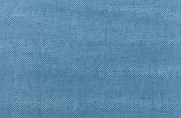 Light blue background from a textile material. Fabric with natural texture. Backdrop.