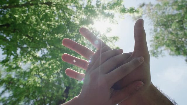 Caressing and holding hands under the sun