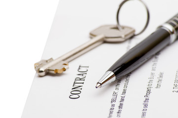 Keys of a new house and pen on contract. 