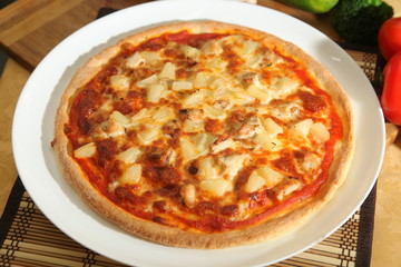 Pizza with pineapple on plate