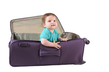 baby girl sitting in a purple suitcase
