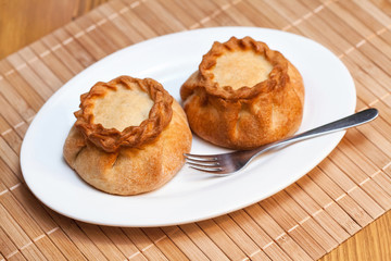 Round pasties stuffed meat on bamboo napkin, close up © hdesert
