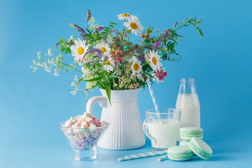 Fresh milk and wildflowers with cookies