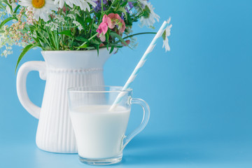 Glass of fresh milk with drinking straw