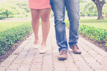 vintage tone of : Male and female leg on the pathway to the garden