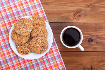Cup of coffee and cookies on the table.