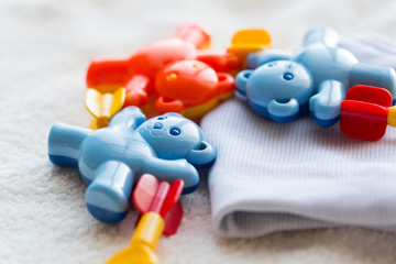 close up of baby rattle and clothes for newborn