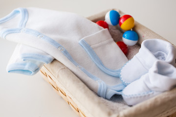 close up of baby clothes for newborn boy in basket