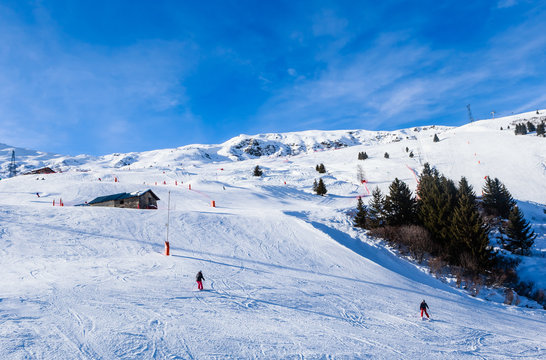 Unidentified skiers enjoy skiing at the slope in the  Alps.  Ski resort Meribel