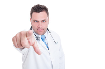 Young male doctor pointing at camera being serious