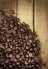 Coffee beans on grunge wooden background