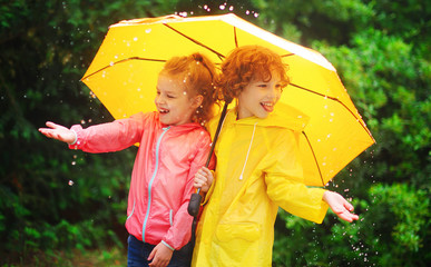 Girl and boy during a rain under one umbrella.