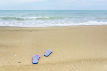 Fototapeta na wymiar Flip-flops on the beach.