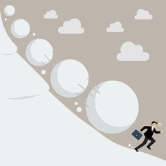 Businessman running away from snowball effect