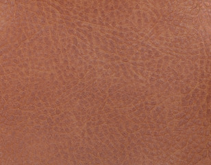 Fototapeta premium Light brown leather background from a textile material. Fabric with natural texture. Backdrop.