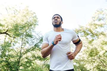 Focused african sportsman running outdoors